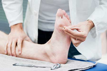 Doctor examining foot